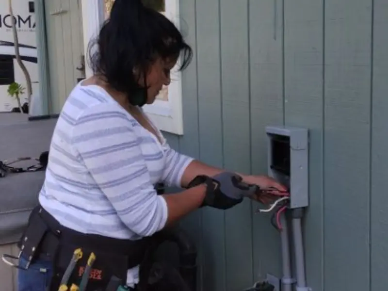 Licensed electrician wiring an exterior subpanel in Fraser